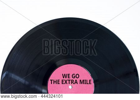 We Go The Extra Mile Symbol. Concept Words We Go The Extra Mile On Retro Black Vinyl Disc. Beautiful