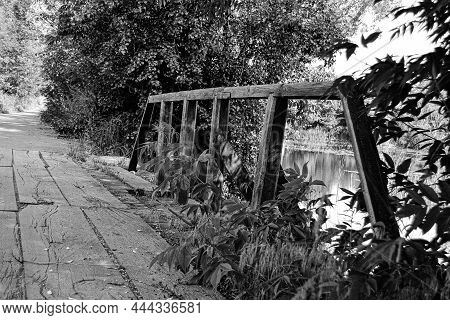 Beautifully Standing Old Wooden Bridge Over River In Colored Background