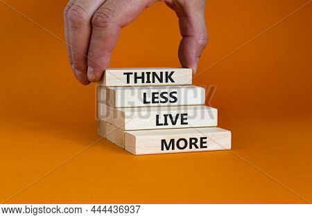 Think Less Live More Symbol. Blocks With Concept Words Think Less Live More On A Beautiful Orange Ba