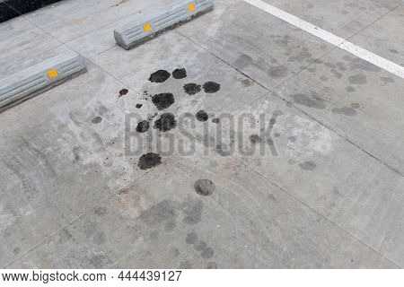 Engine Oil Leakage On Concrete Floor. Black Engine Oil On Concrete Floor. Engine Oil Leak From The E