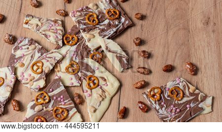 White And Brown Chocolate Prepared For A Broken Chocolate Topped With Pretzel, Sugar Pearls And Nuts