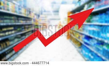 Red Growing Up Large Arrow On Abstract Blur Image Of Supermarket Background. Bar Charts And Graphs. 