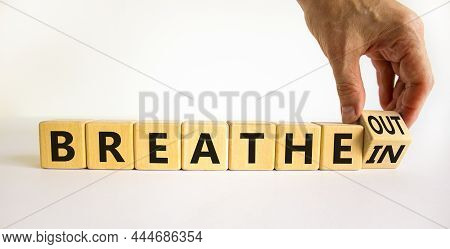 Breathe In And Out Symbol. Doctor Turns A Wooden Cube And Changes Words Breathe In To Breathe Out. B