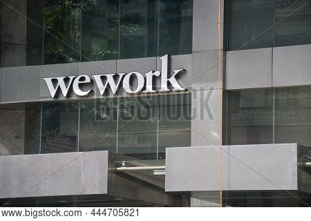 Singapore Dec 26 2021: Name Sign Outside Wework In Singapore. Wework Is A Popular Shared Workspaces 