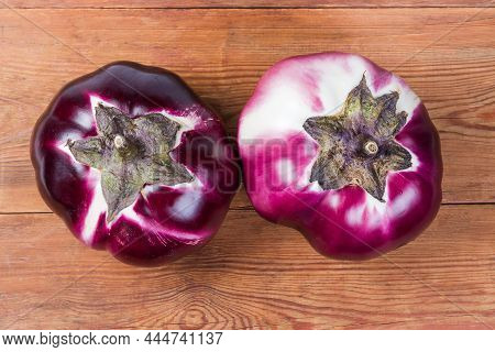 Two Ripe Purple Eggplants Helios Variety On The Old Wooden Rustic Table, Top View From The Peduncles