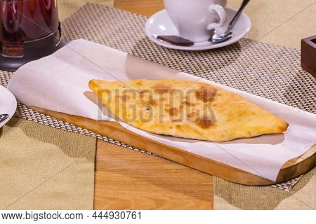 Fresh Lobiani And Khachapuri On A Wooden Table In Organic Packaging. Traditional Georgian Pastries A