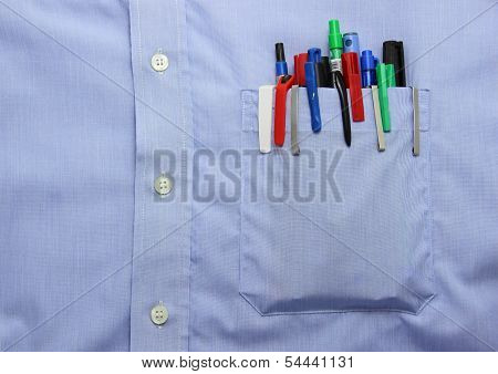 Blue Shirt Pocket With Many Different Ballpoint Pen And Bottoms