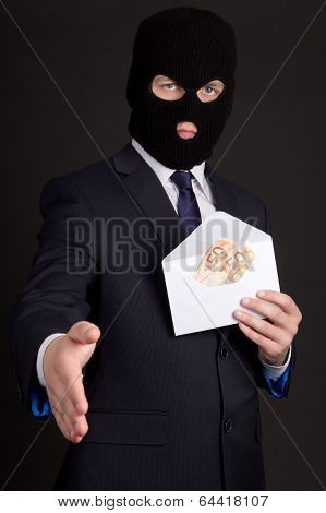 Bribery Concept - Man In Suit And Mask With Money In Envelope Ready To Handshake