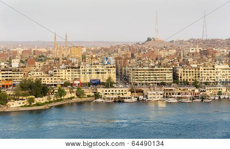 Nile River by Aswan City skyline with Boats