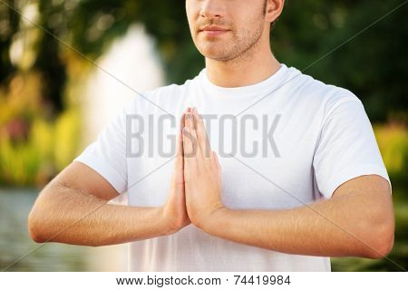 Close-up shot of young man doing yoga