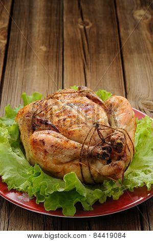 Bondage Shibari Roasted Chicken With Salad Leaves On Red Plate On Wooden Background With Space