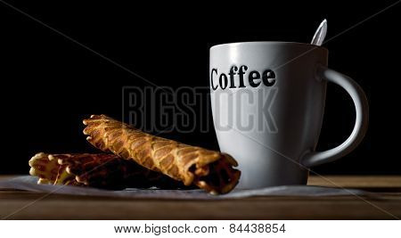 Wafer rolls and cup of coffee.