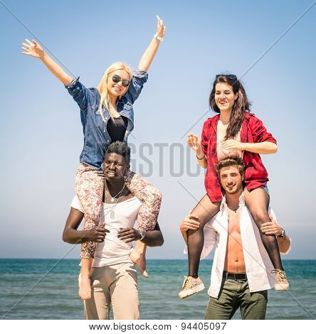 Multiracial Best Friends At Beach Having Fun With Piggyback Game - Spring Summer Concept