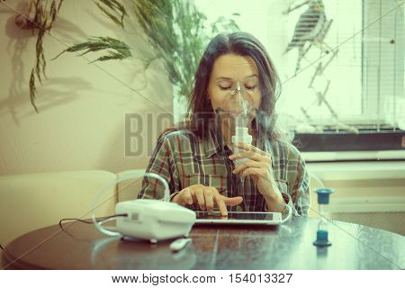 Girl with asthma problems making inhalation with mask on her face
