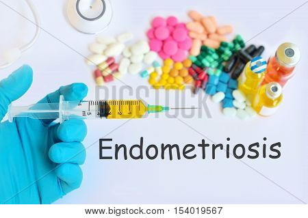 Syringe with drugs for endometriosis treatment, blurred text