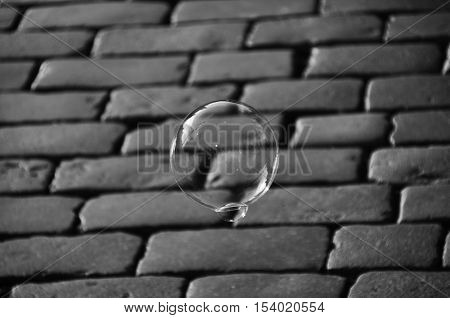 Soap bubble and Cobblestone paving background monochromatic