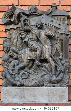 Mukachevo Ukraine - July 21: a bas-relief on the wall closeup with the image of St. George slaying the dragon July 21 2016 in Mukachevo Ukraine