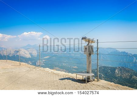 Observation deck with coin-operated telescope or binocular on top of mount Tahtali Kemer Antalya province Turkey. Bright sunny day.
