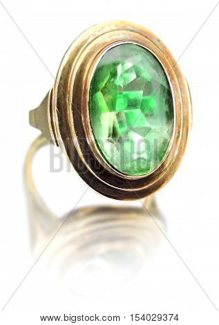 Antique golden ring with green gemstone. Isolated on white background.
