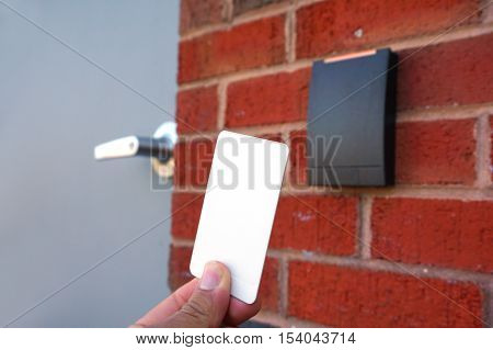 using white entrance card at door entrance card reader