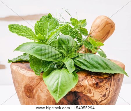 Alternative Medicine Fresh Herbs In The Wooden Mortar . Food Ingredients And Seasoning Basil, Pepper