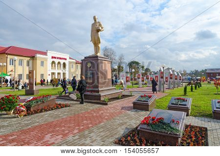 SENNO BELARUS - OCTOBER 8 2016: Alley of Heroes and House of Culture Senno Vitebsk region Belarus. Unidentified people walk on central town square during event Dozhinki-2016