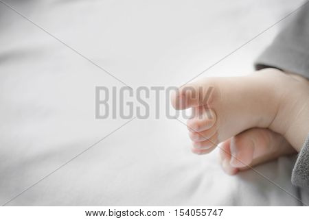 Soft little feet girl on white cloth