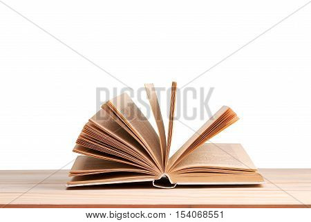 Open book isolated on wooden table. Back to school. Copy space.