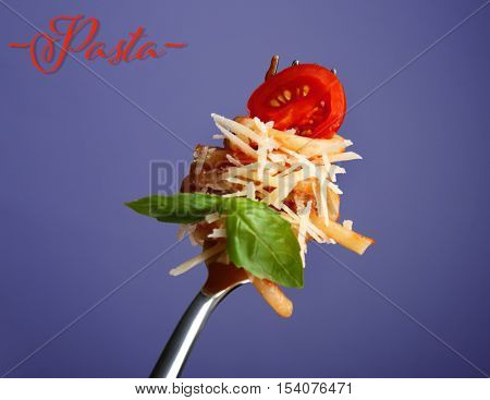 Fork with delicious pasta, tomato, cheese and basil on color background. Italian food concept. Word PASTA on color background.