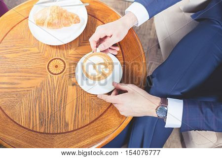 Good morning Close-up handsome male drinking a cup of espresso coffee. Hot beverage. Lunch time. Coffee break. Mustache