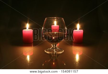 Christmas Photo Cognac Glass And Candle On Black Background