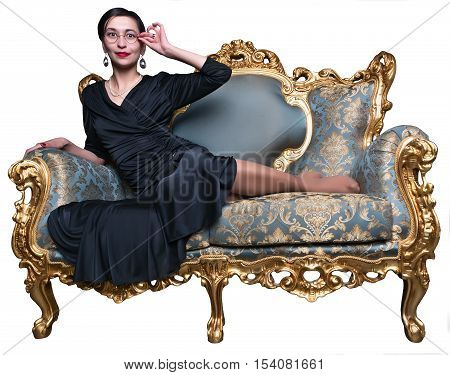 Fashion shoot of beautiful asian woman in a long black dress sitting on classic sofa. Girl looks at camera.