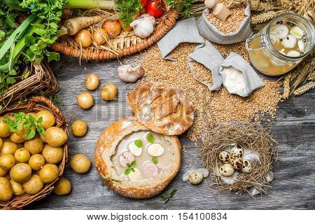Fresh vegetables and homemade soup on old wooden table