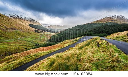 Rain clouds over a mountain valley in cloudy day