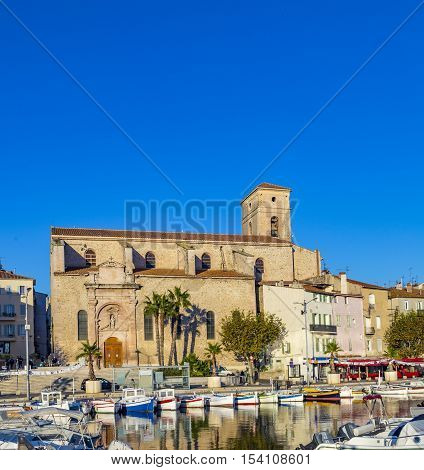 Yachts reflecting in blue water in the old town port of La Ciotat Marseilles district France in the evening light
