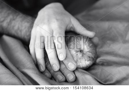 Hands Of A Man And Woman In Bed