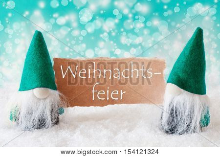 German Text Weihnachtsfeier Means Christmas Party. Christmas Greeting Card With Two Turqoise Gnomes. Sparkling Bokeh Background With Snow. German Text Frohes Fest Means Merry Christmas