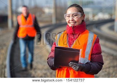Man and a woman railroad workers maintaing railway