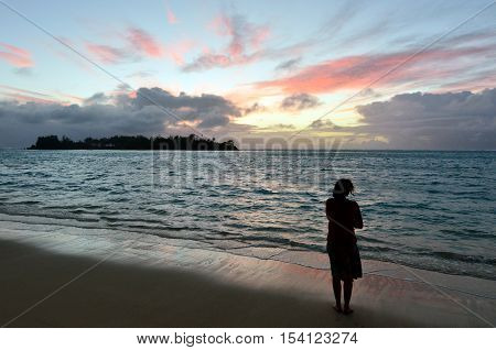 Young Woman Looks At The Sunrise Of Tropical Island