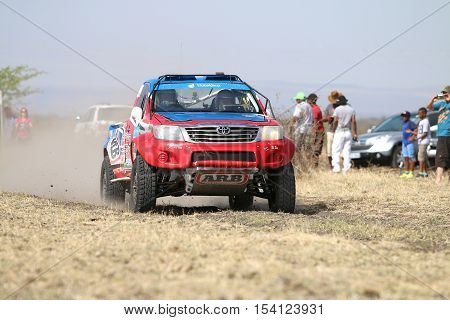 Speeding Red And Blue Toyota Hilux Single Cab Rally Car Front View