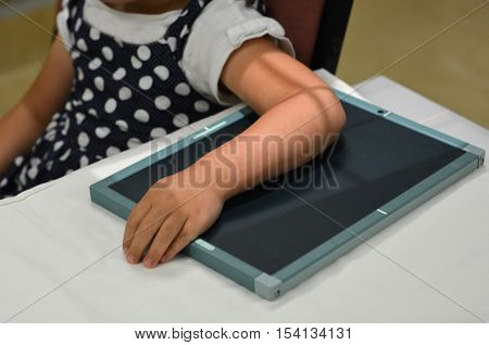 Little child girl arm during an X-ray radiography.