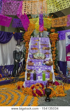 XALAPA, VERACRUZ, MEXICO- OCTOBER 28, 2016: Traditional mexican day of the dead offering altar with a catrin in Xalapa, Veracruz, Mexico