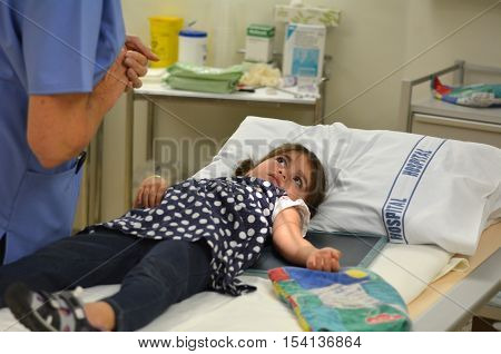 KAITAIA NZ - MAR 06:Little girl (Talya Ben-Ari age 3) during X-ray arm radiography on Mar 06 2014.X-rays are used to help treat disesases such as cancer or a tumor by exposing them to the radiation.
