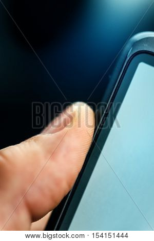 Unlocking smart phone with fingerprint sensor scan close up with selective focus