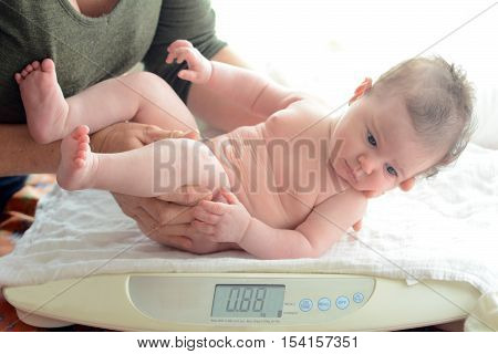 Infant Baby Been Examined On The Balance