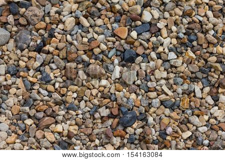Small pebbles rock on the shore background