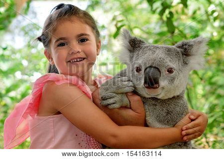 Little Girl Hugs Koala