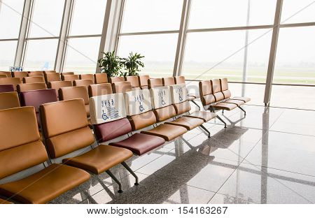 Waiting area at airport gate. Seats for persons with disability. Empty departure lounge. Waiting to board.