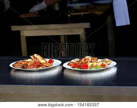 Two plates with meat dish and garnish
