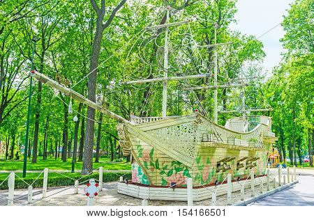 KHARKOV UKRAINE - MAY 20 2016: The old warship covered with colorful roses in Gorky Park of Kharkov  on May 20 in Kharkov.